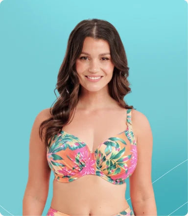 Model wearing a tropical print swimsuit